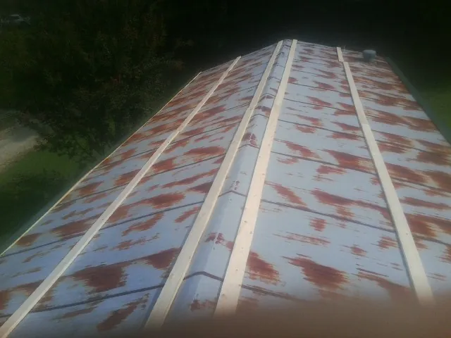 Rusted metal roof panels with new wood purlins before replacement — Storm Damage Roof Repair in Manchester Township by Roofing Brothers