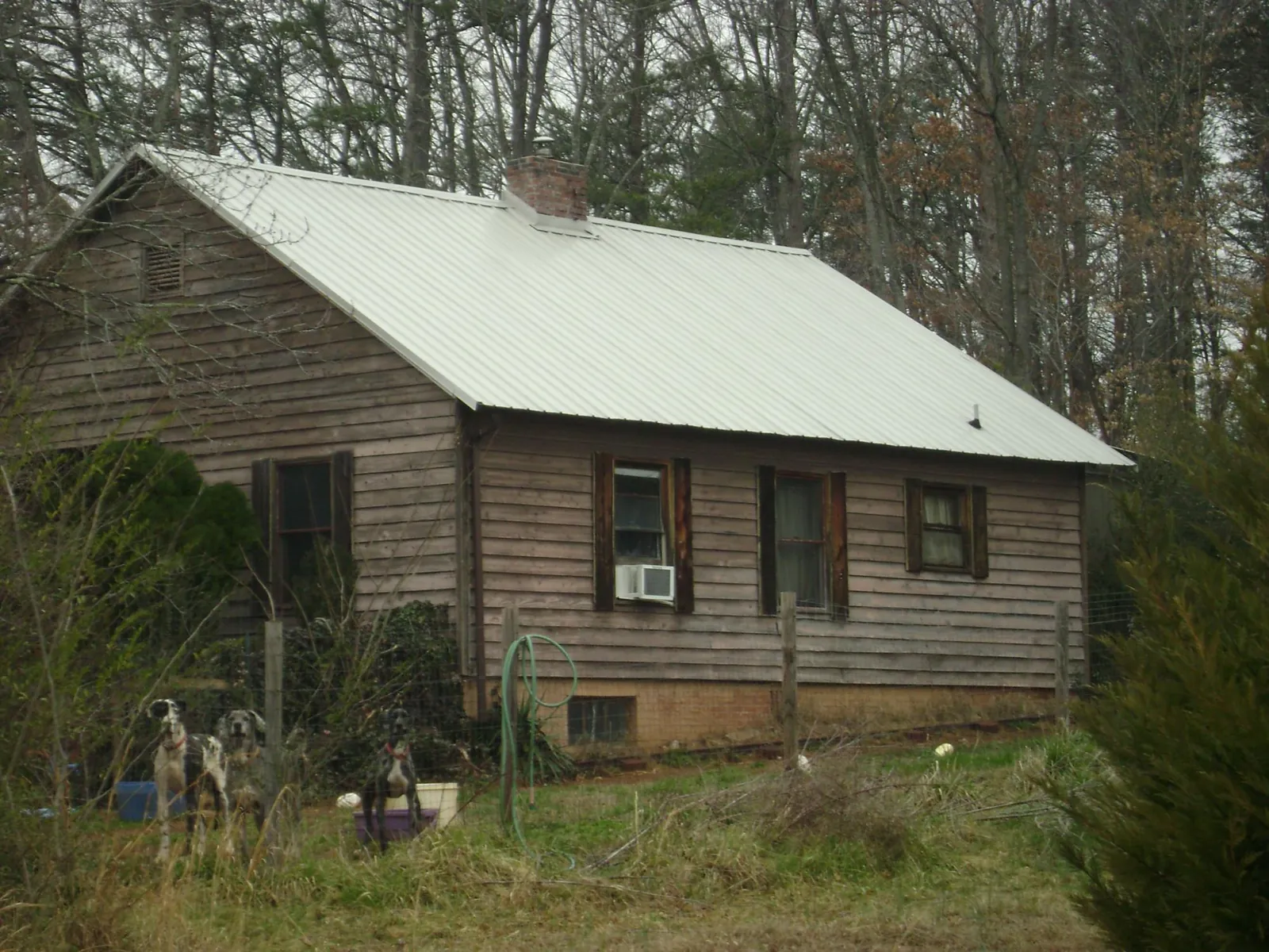 White metal roof on an old wood sided farmhouse, from a Metal Roof Installation job in Manchester Township